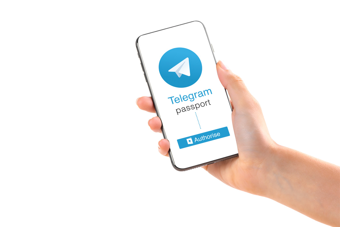 Poltava, Ukraine - July 28, 2018: Telegram application logo on smartphone in hands passport verification new feature